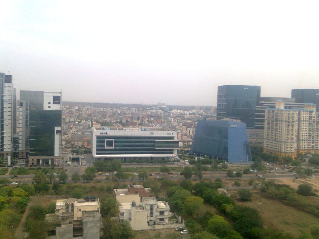 Real Gurugram skyline with office buildings, homes and road network
