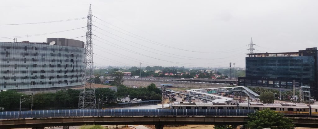IFFCO Chowk in Gurugram, Haryana, with a Delhi Metro train, road junction and office buildings